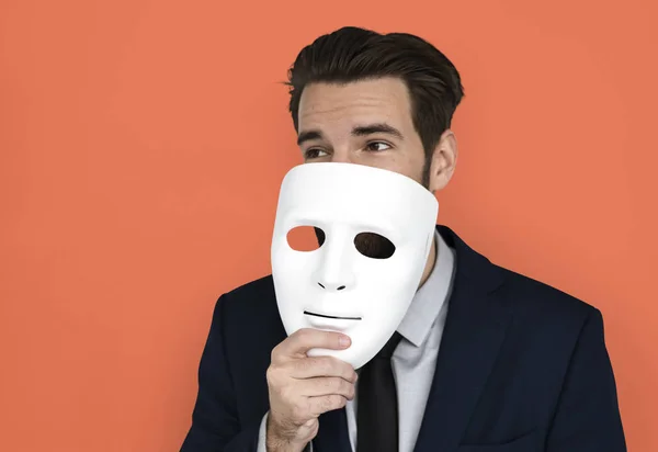 Empresário segurando máscara — Fotografia de Stock