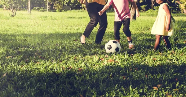 Мама играет в футбол с дочерьми — стоковое фото