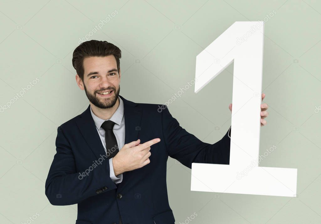 Businessman holding number one