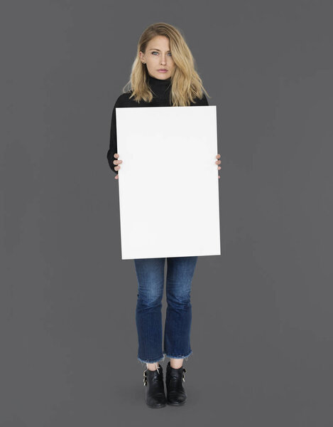 woman holding white paper banner