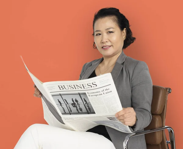 Asian woman reading newspaper — Stock Photo, Image