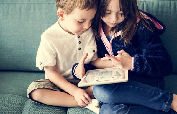 Zus en broer met behulp van digitale tablet — Stockfoto