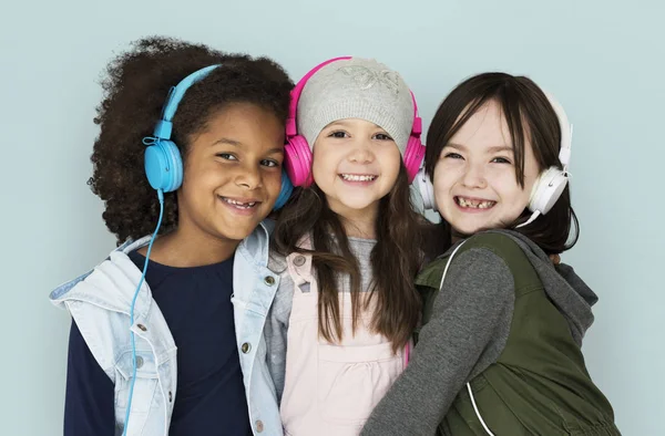Girls listening music in headphones — Stock Photo, Image