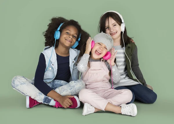 Meninas ouvindo música em fones de ouvido — Fotografia de Stock