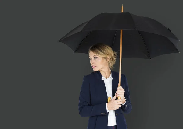 Studio shoot of businesswoman with Umbrella — Stock Photo, Image
