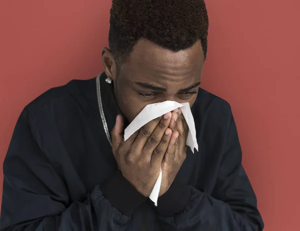Sick African man sneezing — Stock Photo, Image