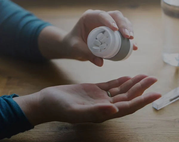 Sick person taking pills — Stock Photo, Image