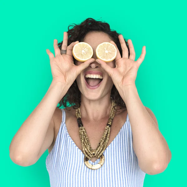 woman covering eyes by lemon slices