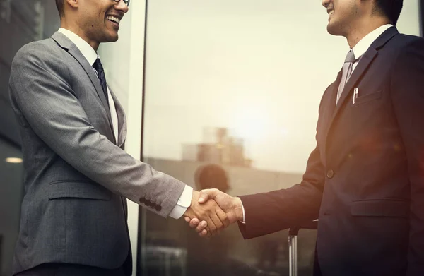 Businessmen handshaking and smiling — Stock Photo, Image