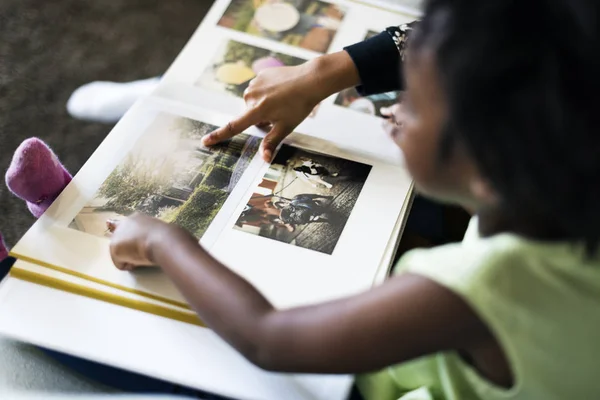 Girl watching photo album — Stock Photo, Image