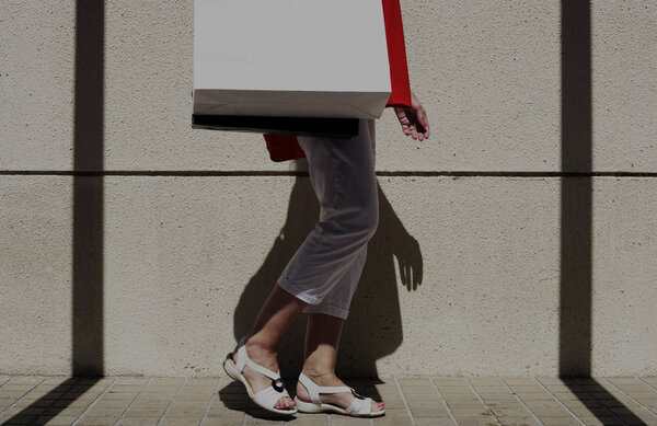 Woman walking with shopping bag