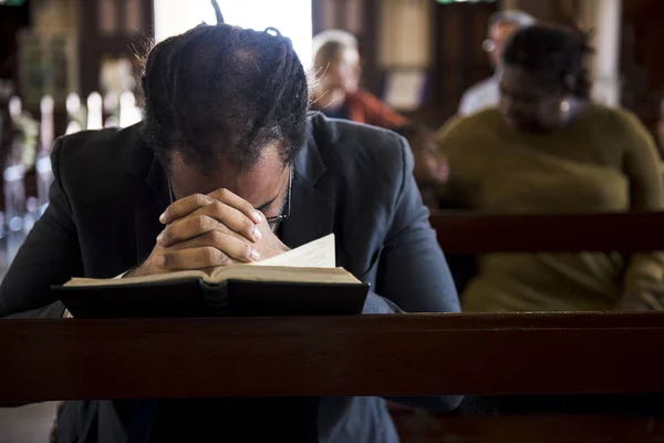 Homem orando na igreja — Fotografia de Stock