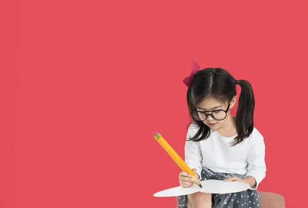 Girl writing with big pencil — Stock Photo, Image