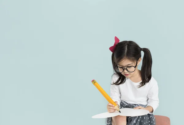 Girl writing with big pencil — Stock Photo, Image