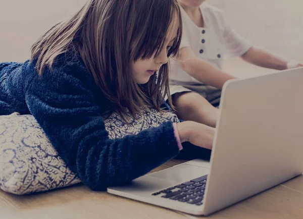 Little brother and sister using laptop — Stock Photo, Image