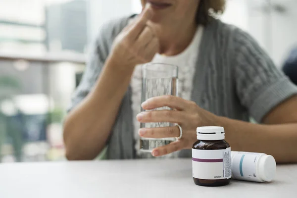 Woman drinking pills — Stock Photo, Image