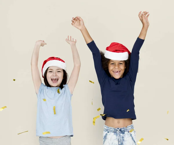 Crianças felizes vestindo chapéus de Santa — Fotografia de Stock