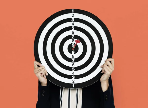 Woman holding darts — Stock Photo, Image