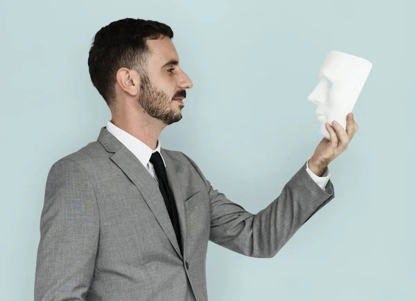 Caucasian businessman holding mask — Stock Photo, Image