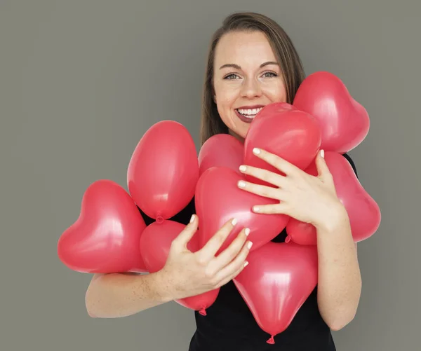 Lady Hugging heart balloons — Stock Photo, Image