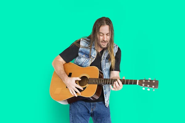 Mannen med långt hår poserar i studio — Stockfoto