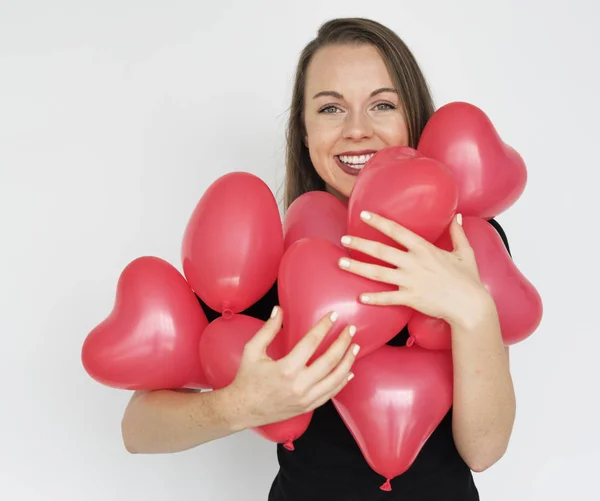 Lady Hugging heart balloons — Stock Photo, Image
