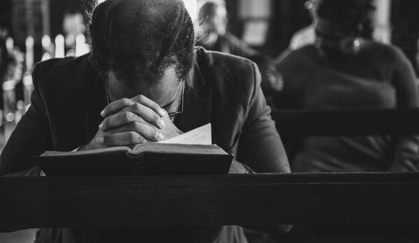 man praying in church