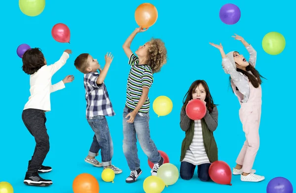 Ομάδα από παιδιά που έπαιζαν με πολύχρωμα μπαλόνια — Φωτογραφία Αρχείου