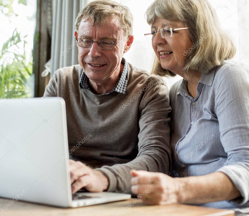 Senior couple using laptop 