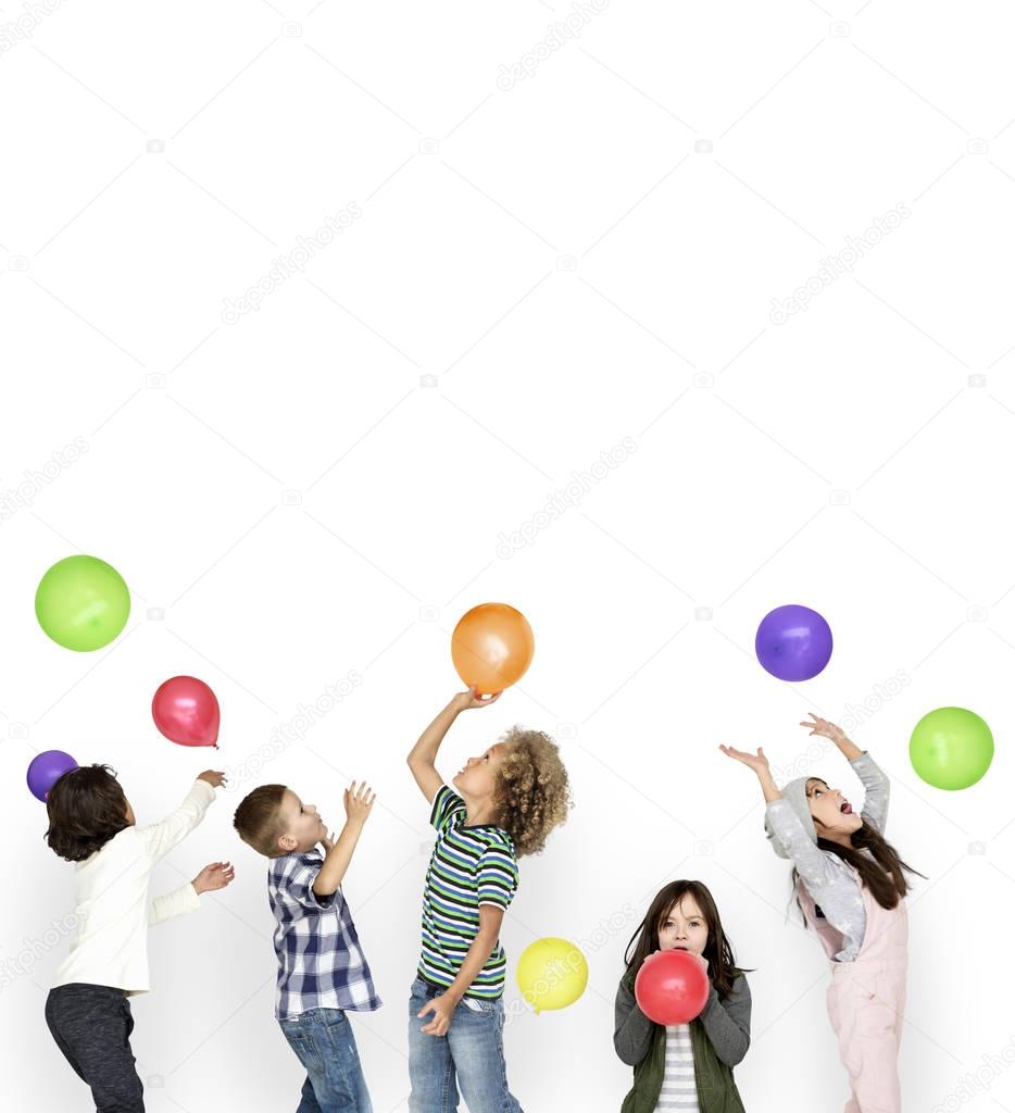 group of children playing with colorful balloons