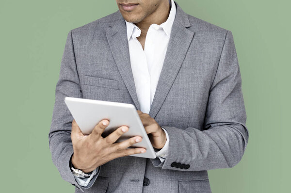 Studio shoot of businessman using Tablet