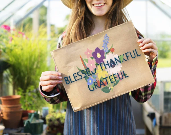 Young woman in hat holding poster — Stock Photo, Image