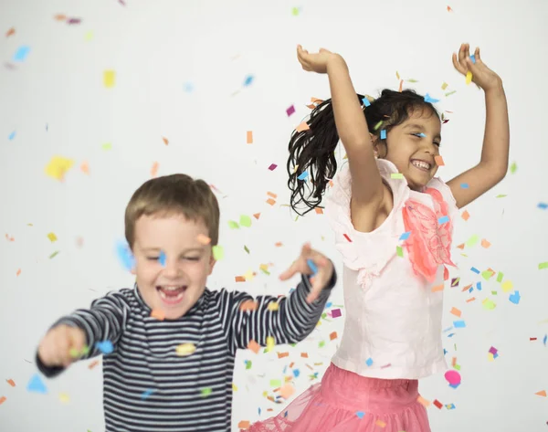 Children playing in confetti — Stock Photo, Image