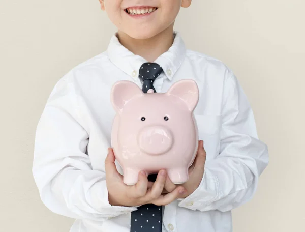 Chico holding piggybank —  Fotos de Stock