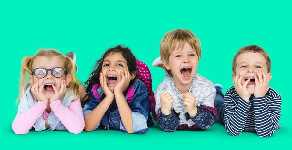 Multi ethnic children laying on floor — Stock Photo, Image