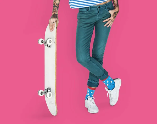 Женщина, держащая скейтборд — стоковое фото