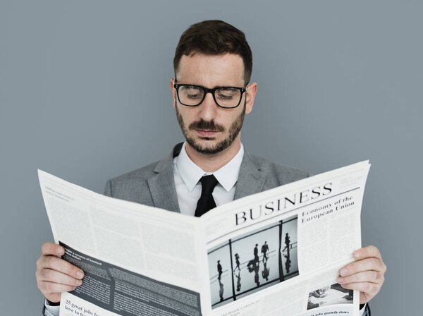 bearded Businessman reading newspaper 
