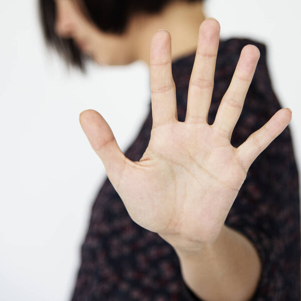 person gesturing stop hand