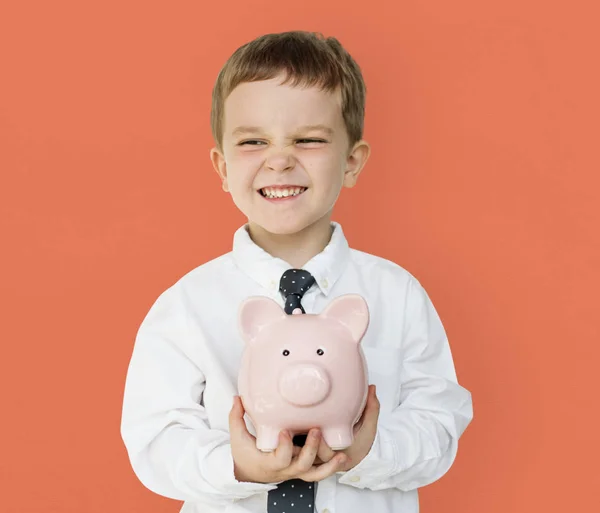 Chico holding piggybank —  Fotos de Stock