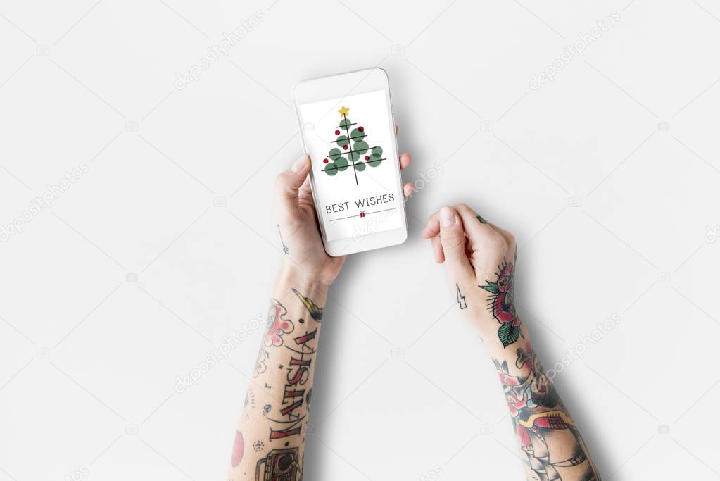 smartphone in tattooed hands