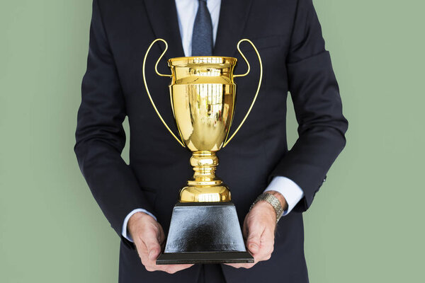 man Holding golden Trophy