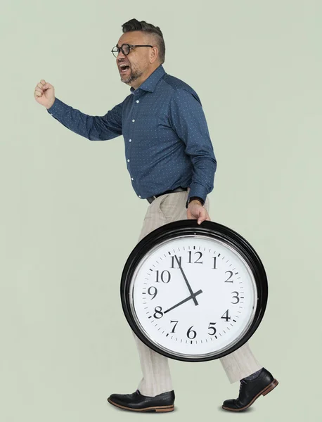Hombre de negocios sosteniendo reloj —  Fotos de Stock