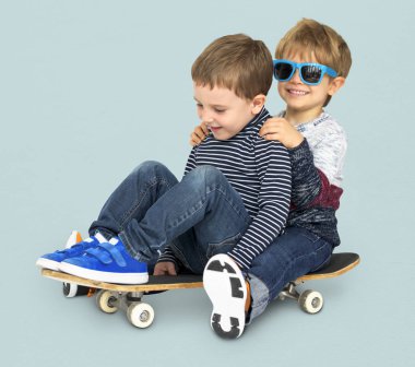 mutlu küçük çocuklar kaykay üzerinde sürme