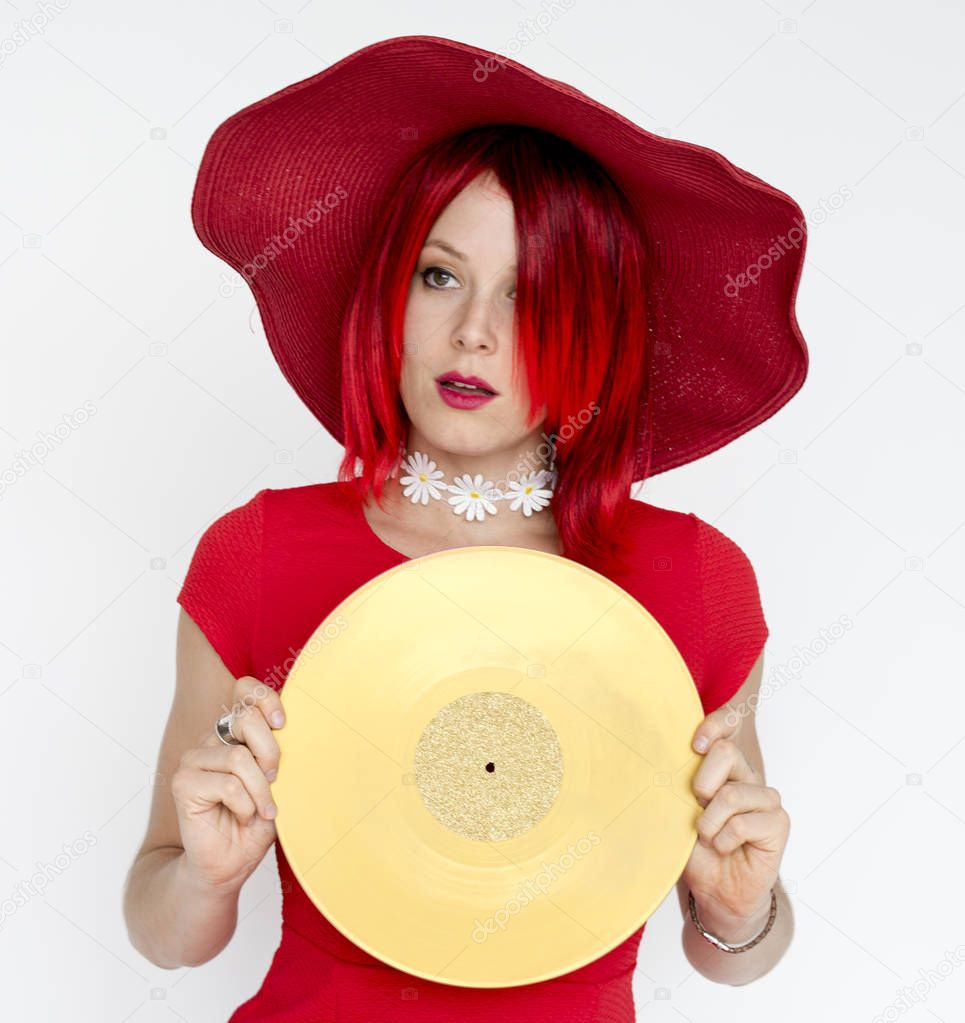 woman with red hair holding vinyl