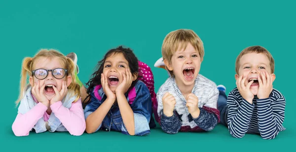 Multi ethnic children laying on floor — Stock Photo, Image