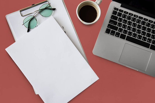 laptop and papers at workplace table