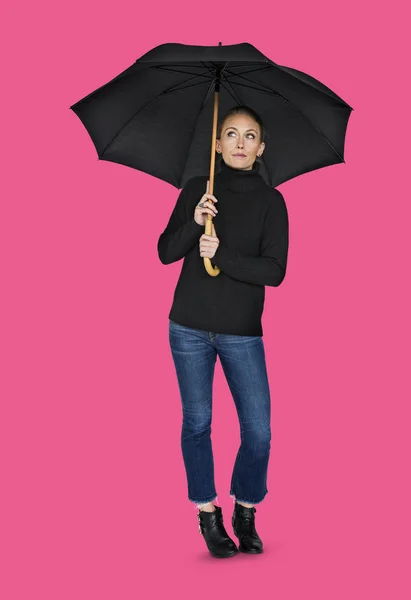 Woman holding umbrella in studio — Stock Photo, Image