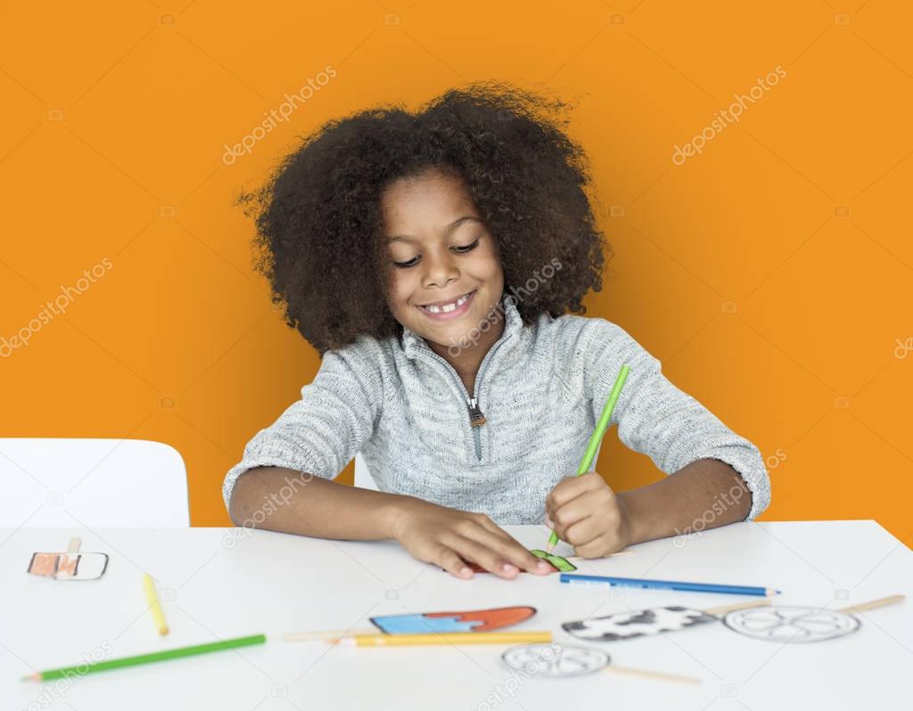 adorable african kid drawing