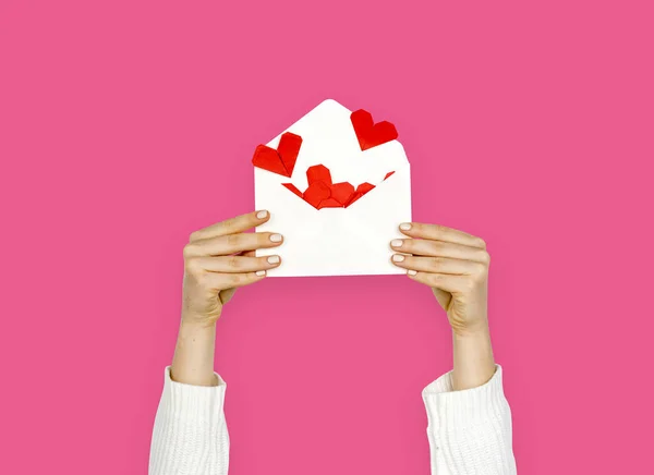 Woman holding envelope with hearts — Stock Photo, Image