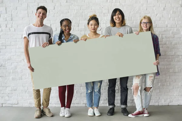 Amigos sosteniendo la pancarta juntos — Foto de Stock